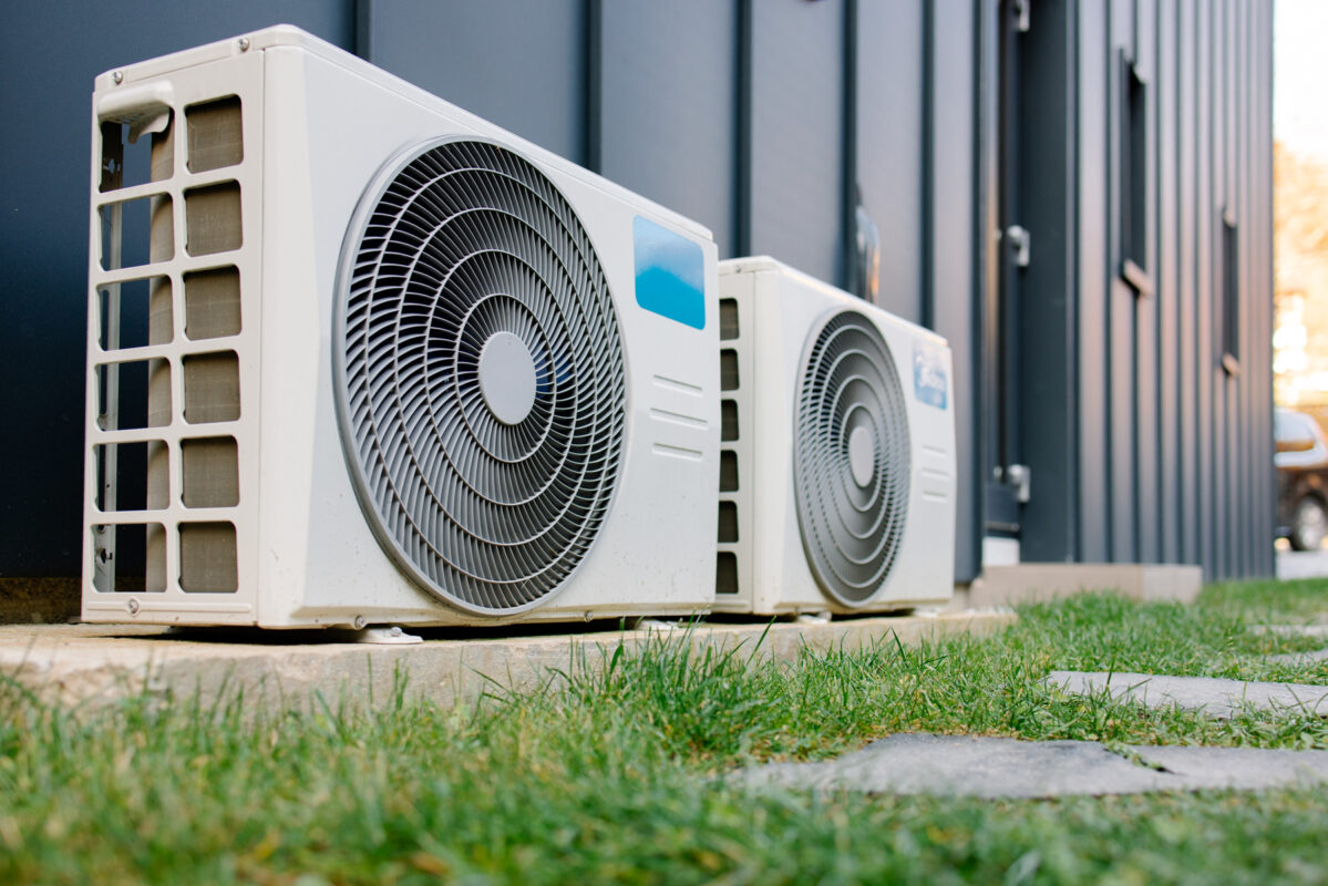 Small air conditioning condenser units outside a commercial building.